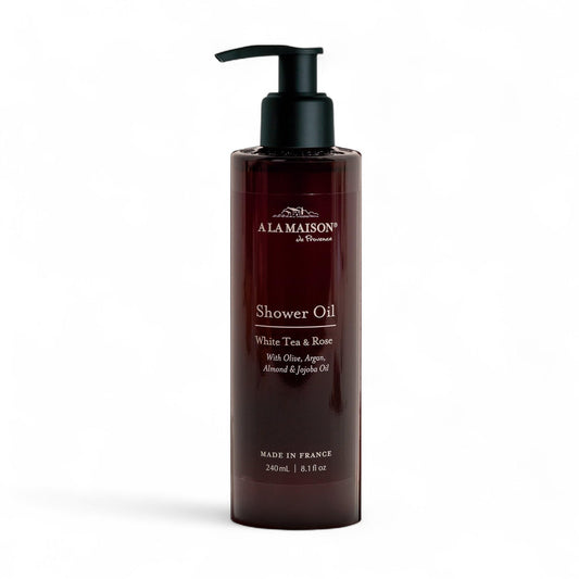 A LA MAISON cleansing shower oil bottle featuring White Tea & Rose for hydrated cleansing.