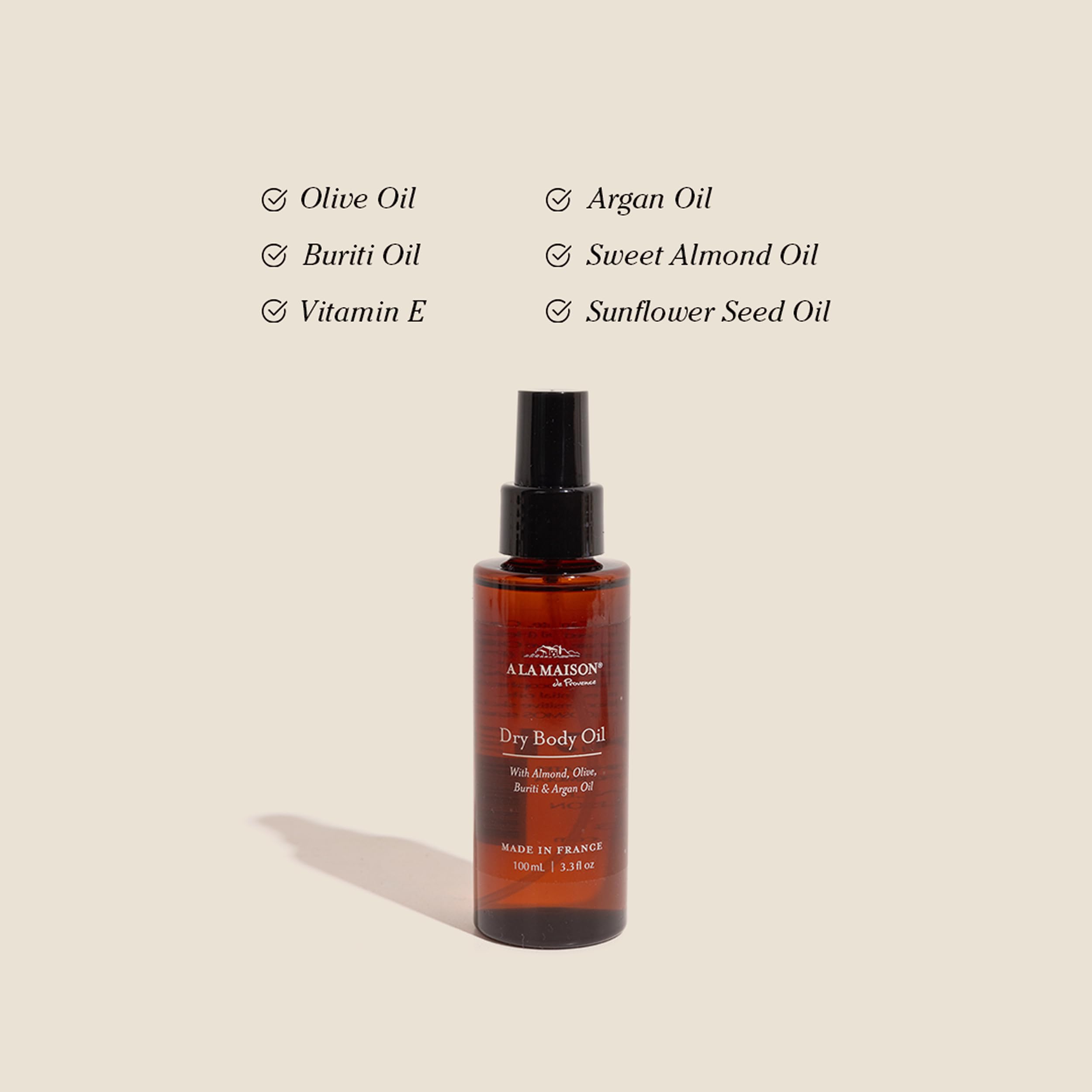 A LA MAISON bottle close up highlights sweet almond oil for nourishing skin.