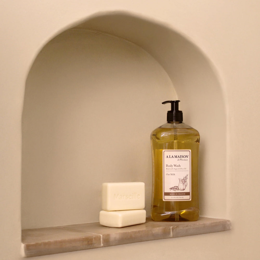 A LA MAISON Oat Milk Body Wash bottle side profile shows compact packaging.