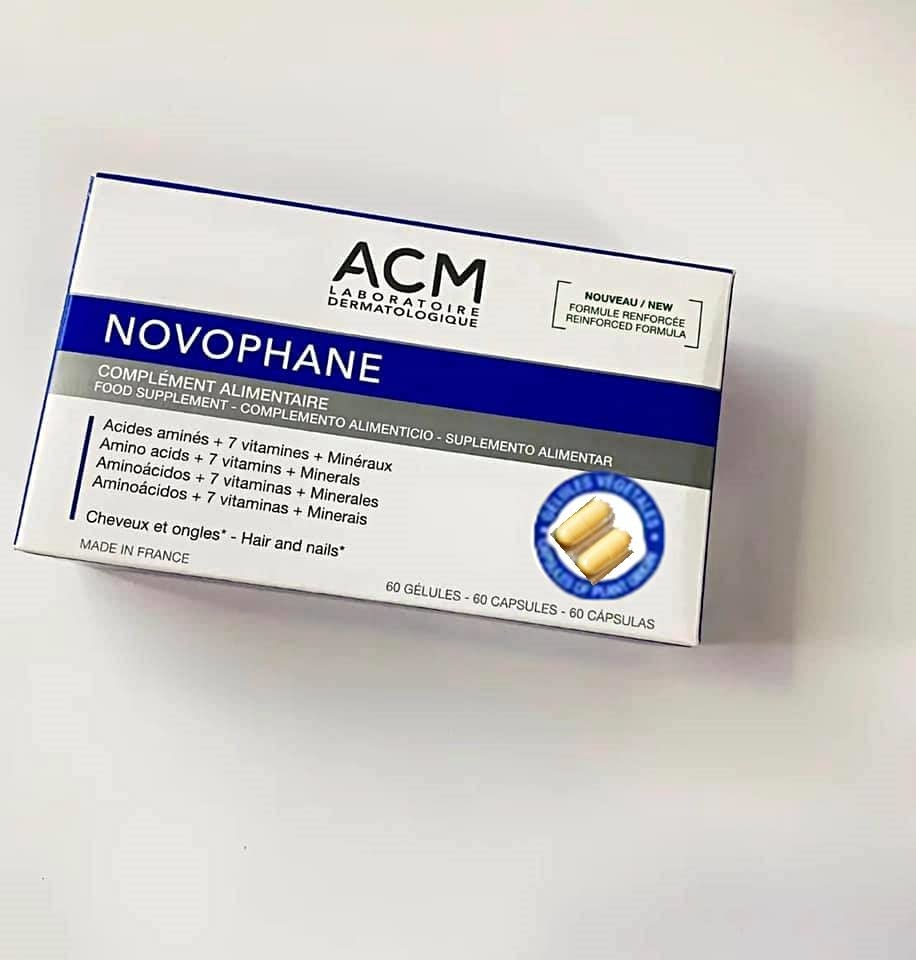 ACM Novophane bottle and glass of water on a bathroom vanity.