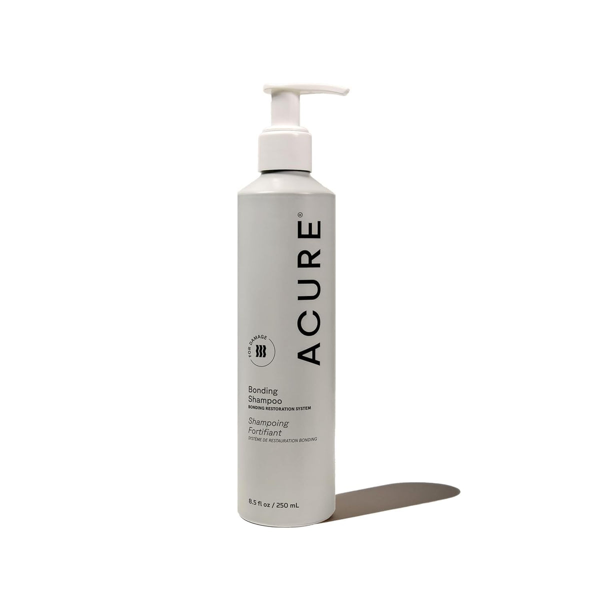 Acure Bonding Shampoo bottle closeup highlighting hydrating formula for dry, damaged hair.