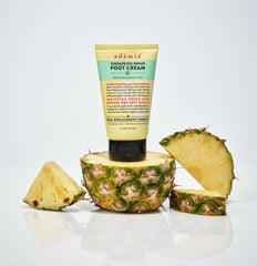 Hands applying Adamia foot cream to tired feet after a long day.