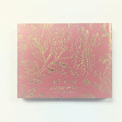AERIN Tuberose Gardenia fragrance vial, lush floral with vanilla warmth for evening occasions.