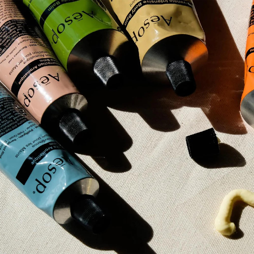 Aesop Reverence Aromatique Hand Balm aluminum tube close-up emphasizes recycled packaging.