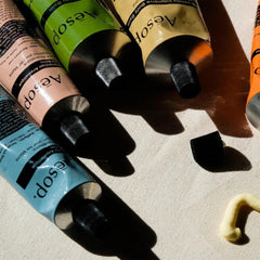 Aesop Reverence Aromatique Hand Balm aluminum tube close-up emphasizes recycled packaging.