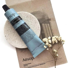 Aesop Reverence Aromatique Hand Balm with shea butter close-up reveals rich emollient texture.