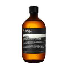 Aesop Shampoo Refill bottle pour demonstrates easy dispensing and eco-friendly design.