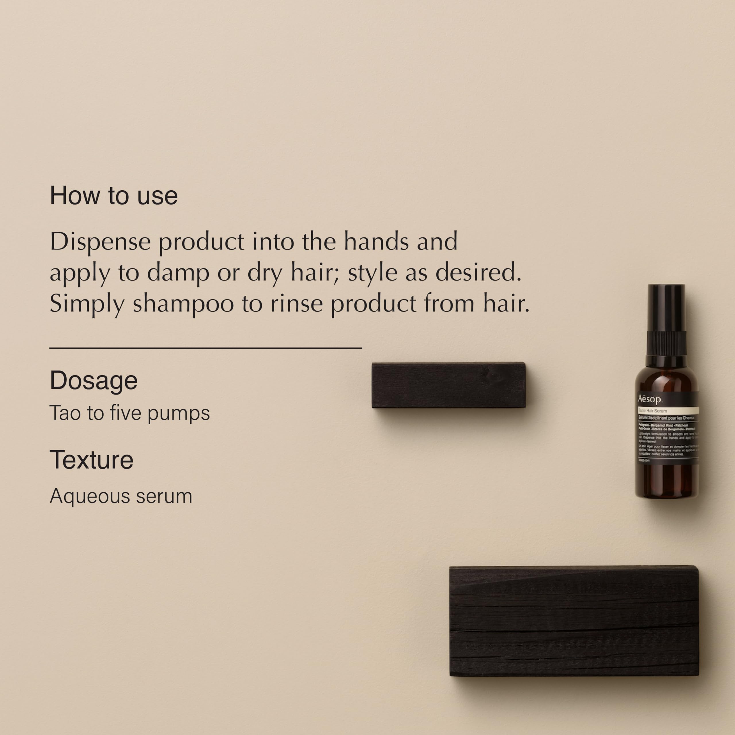 Dispensing Aesop Tame Hair Serum into hands for smoothing damp hair.