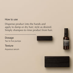 Dispensing Aesop Tame Hair Serum into hands for smoothing damp hair.