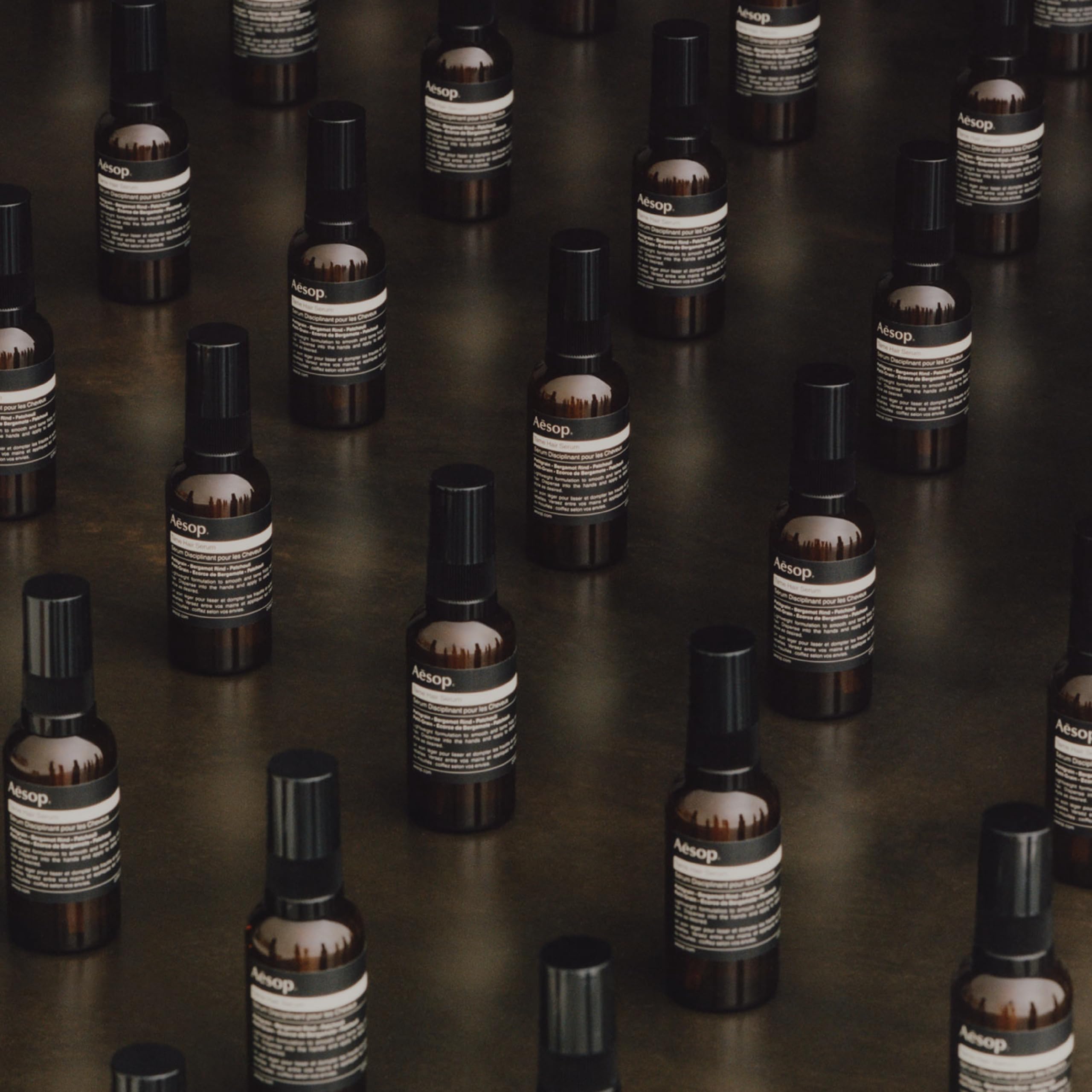 Aesop Tame Hair Serum on dry hair with light shine.