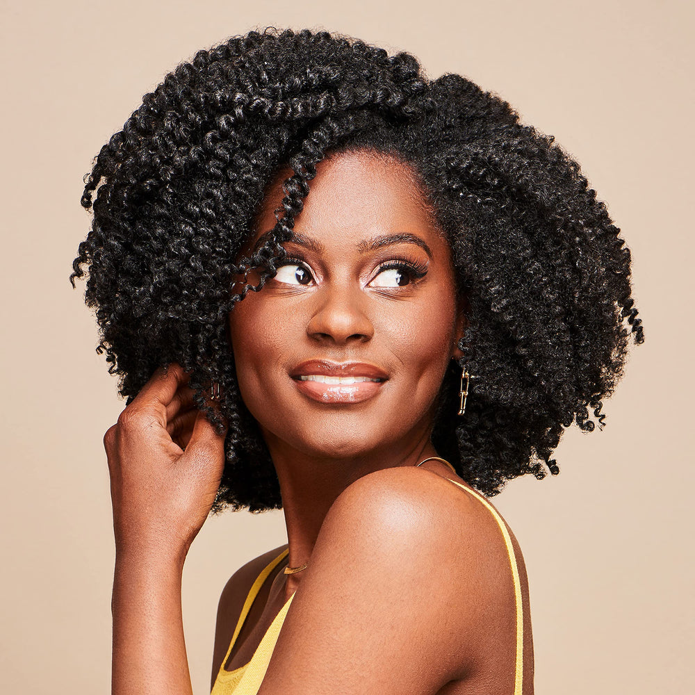 African Pride Moisture Miracle bottle close-up highlights premium natural ingredients