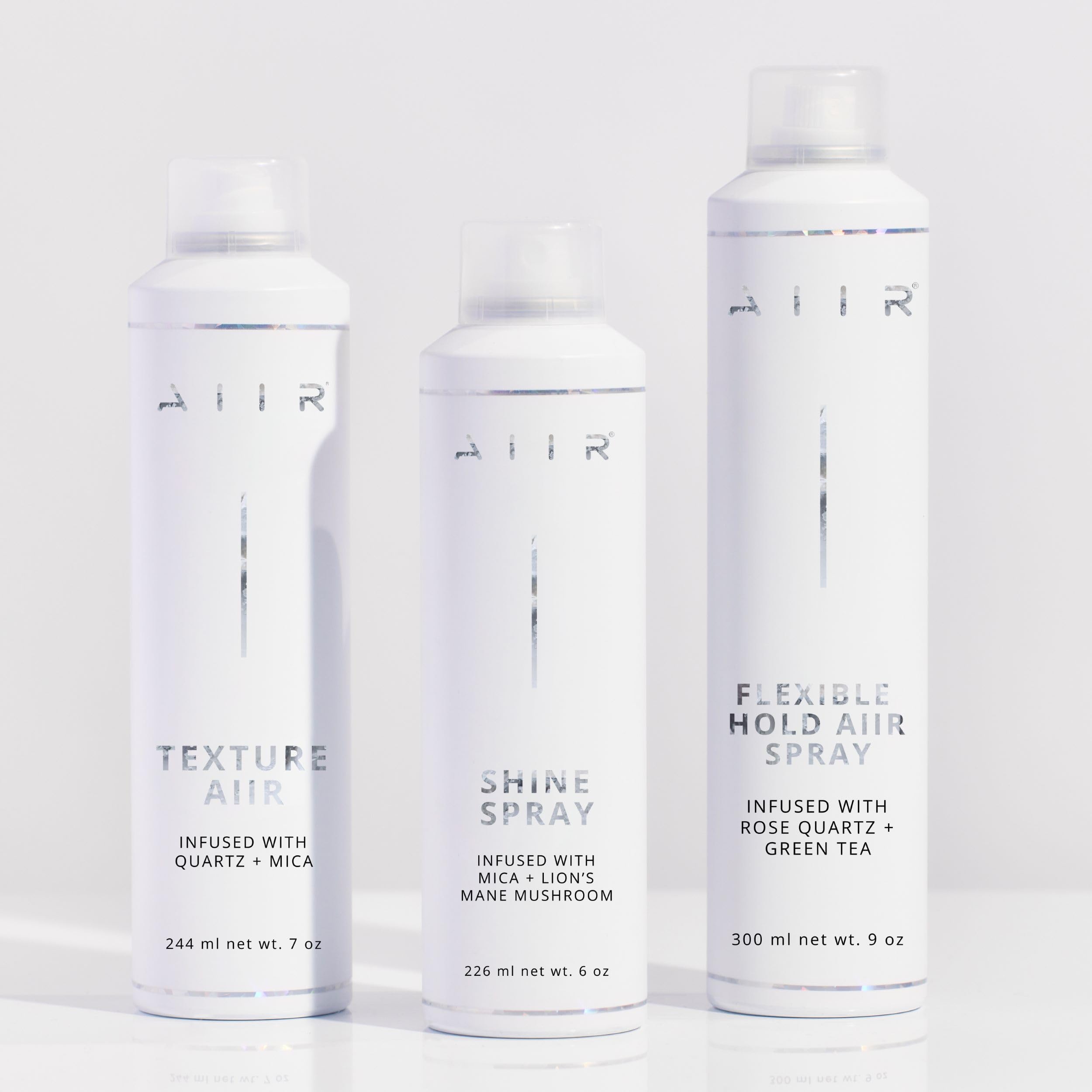 AIIR Shine Spray on curls providing humidity resistance and shine.