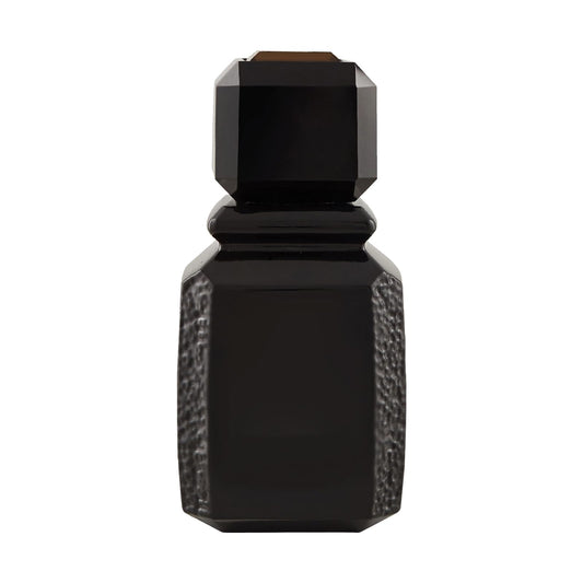 Ajmal Patchouli Wood closeup highlighting warm amber tones and textured glass for luxury appeal.