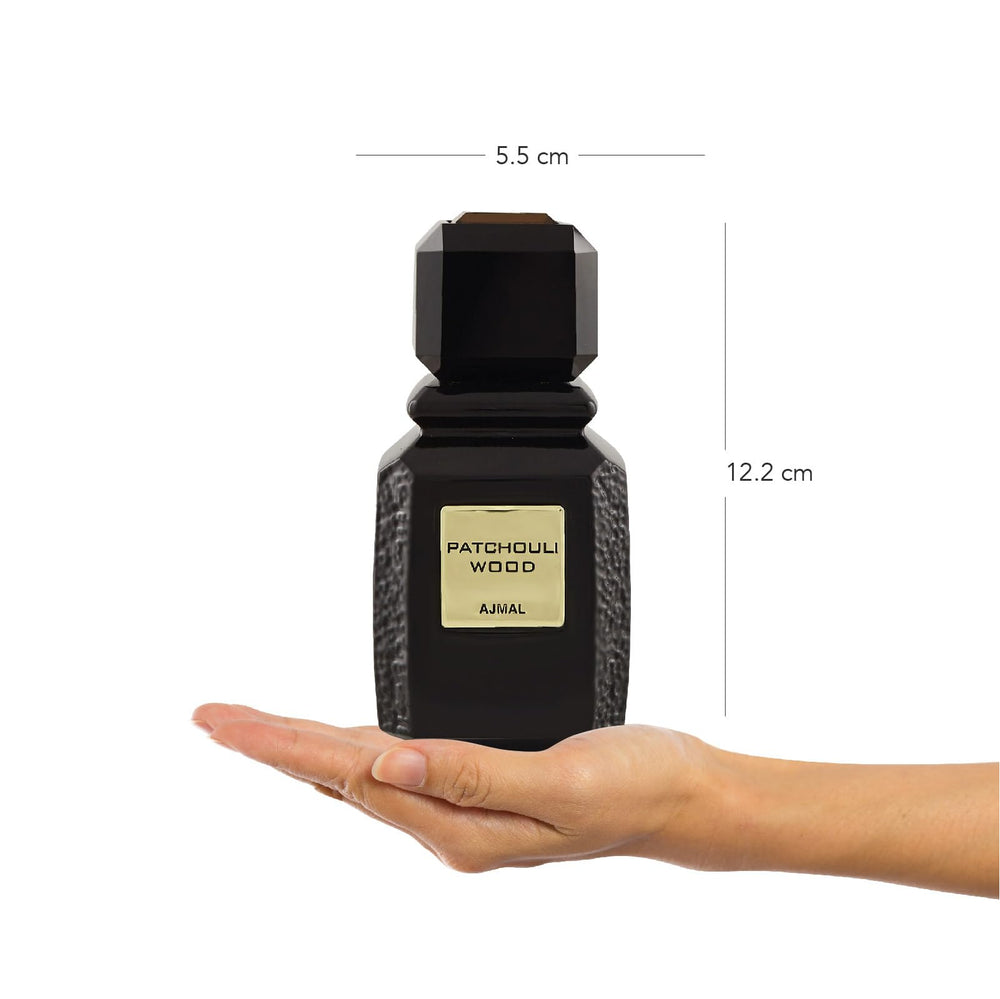 Ajmal Patchouli Wood liquid visible through the bottle hinting at a warm spicy-woody profile.