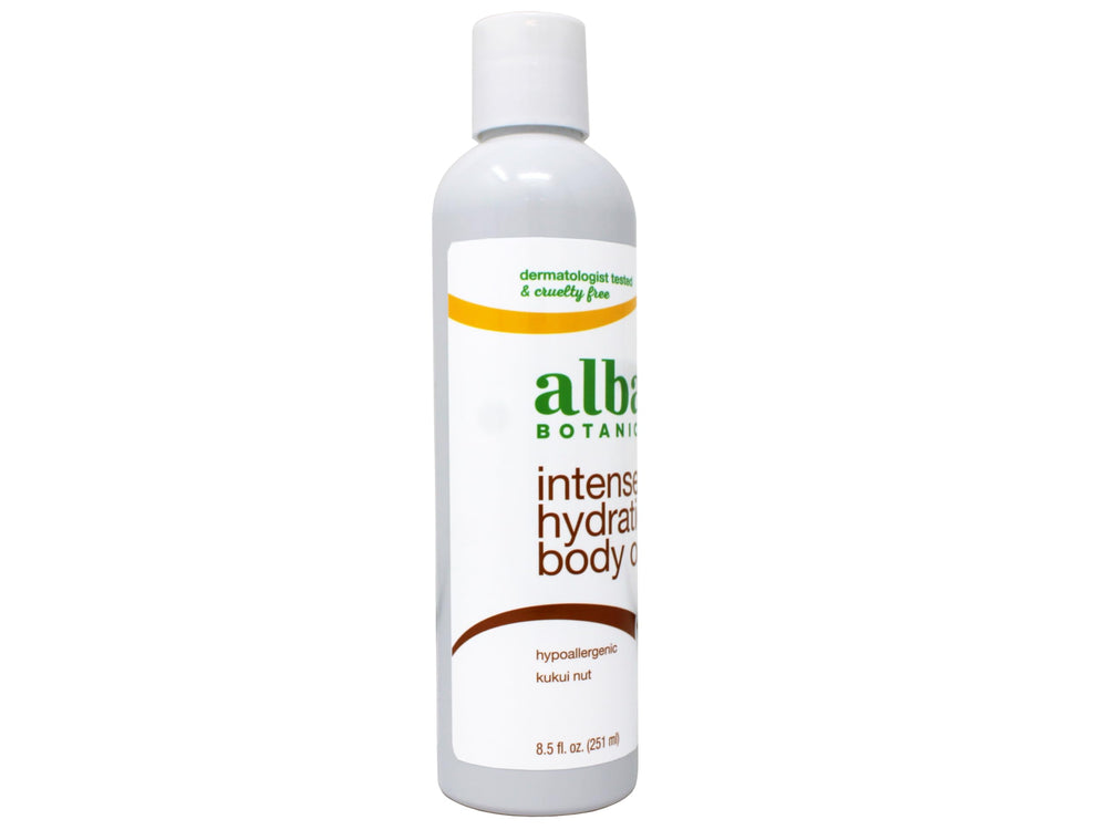 Alba Botanica kukui nut body oil bottle pouring to illustrate quick absorption.