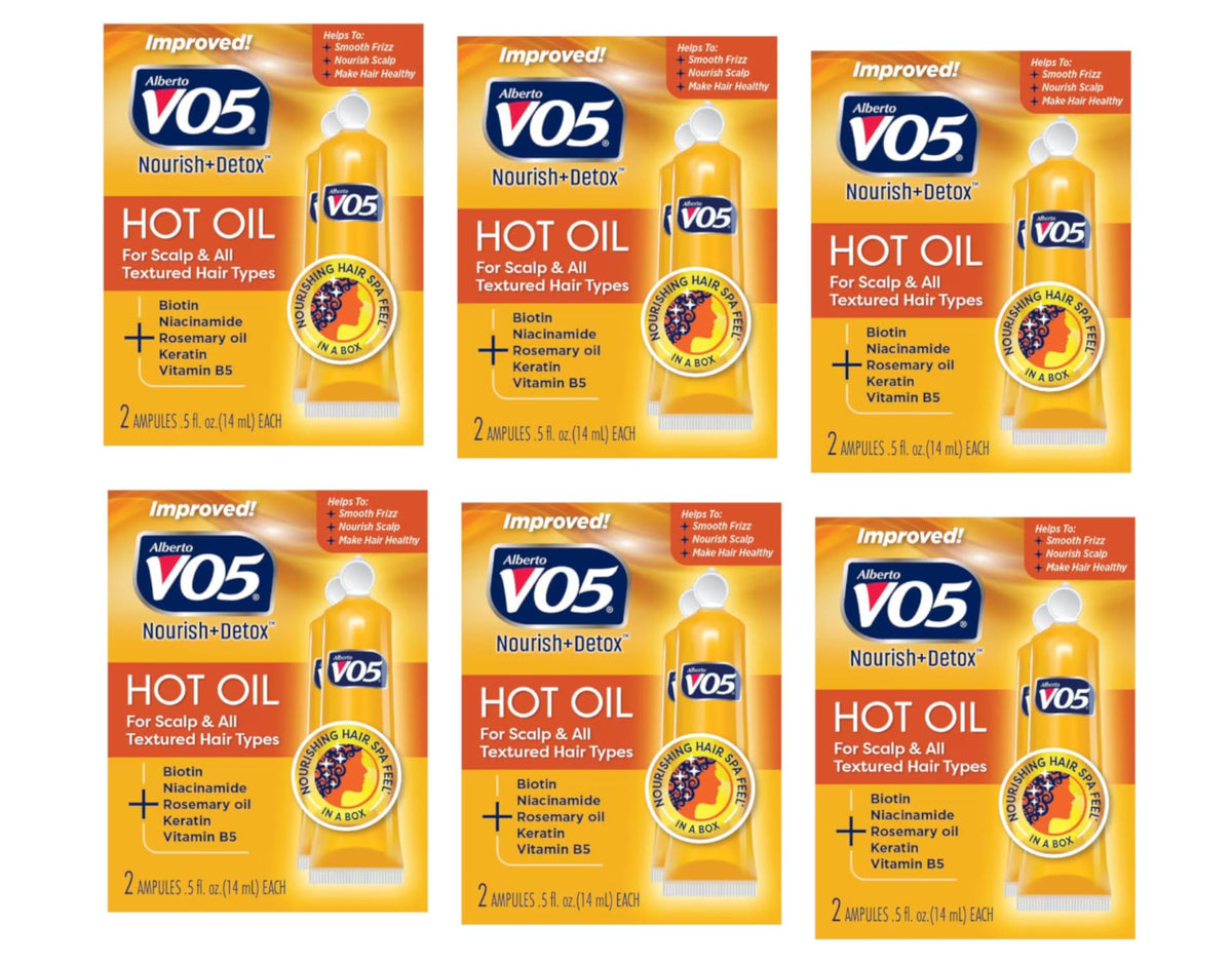 Alberto VO5 moisturizing hot oil tubes in hand for smooth, hydrated hair.