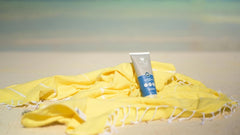 A person applying Aloe Up sunscreen before an outdoor hike.