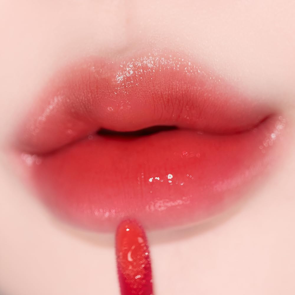 Alternativestereo Lip Potion Aqua Glow Apple Drop swatch reveals sheer red radiance.