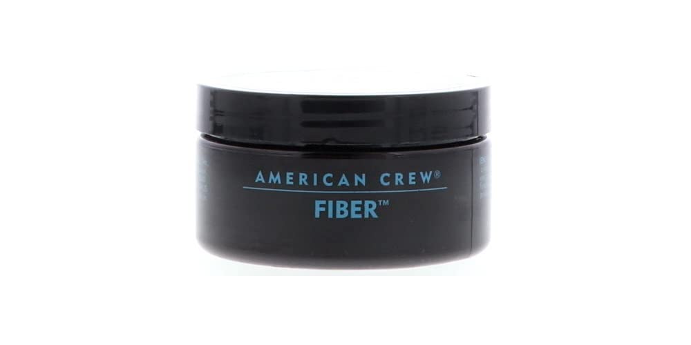Hands applying American Crew Men Fiber for added texture.