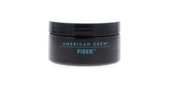 Hands applying American Crew Men Fiber for added texture.