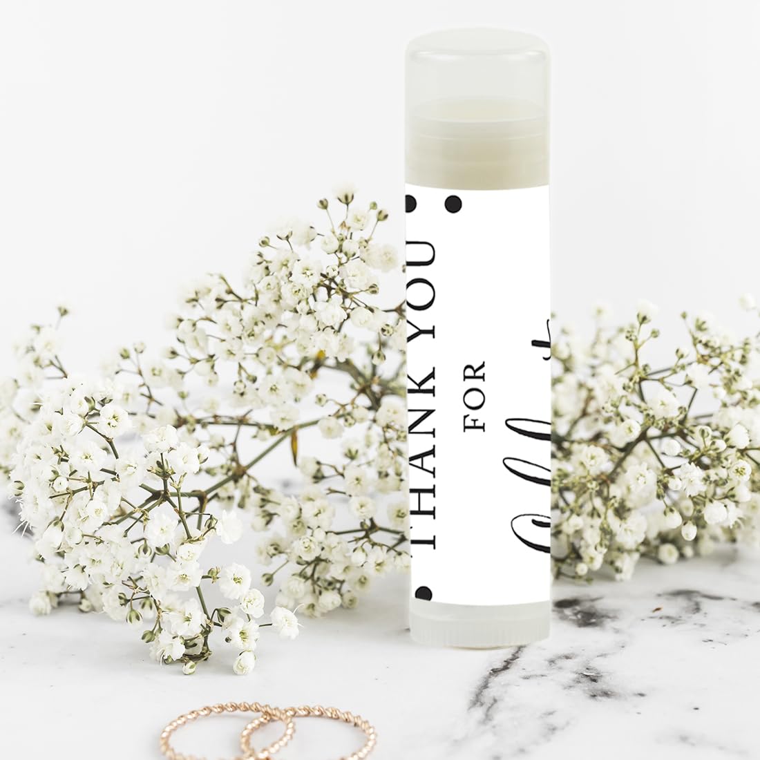 Step-by-step DIY assembly of lip balm favors with adhesive stickers.