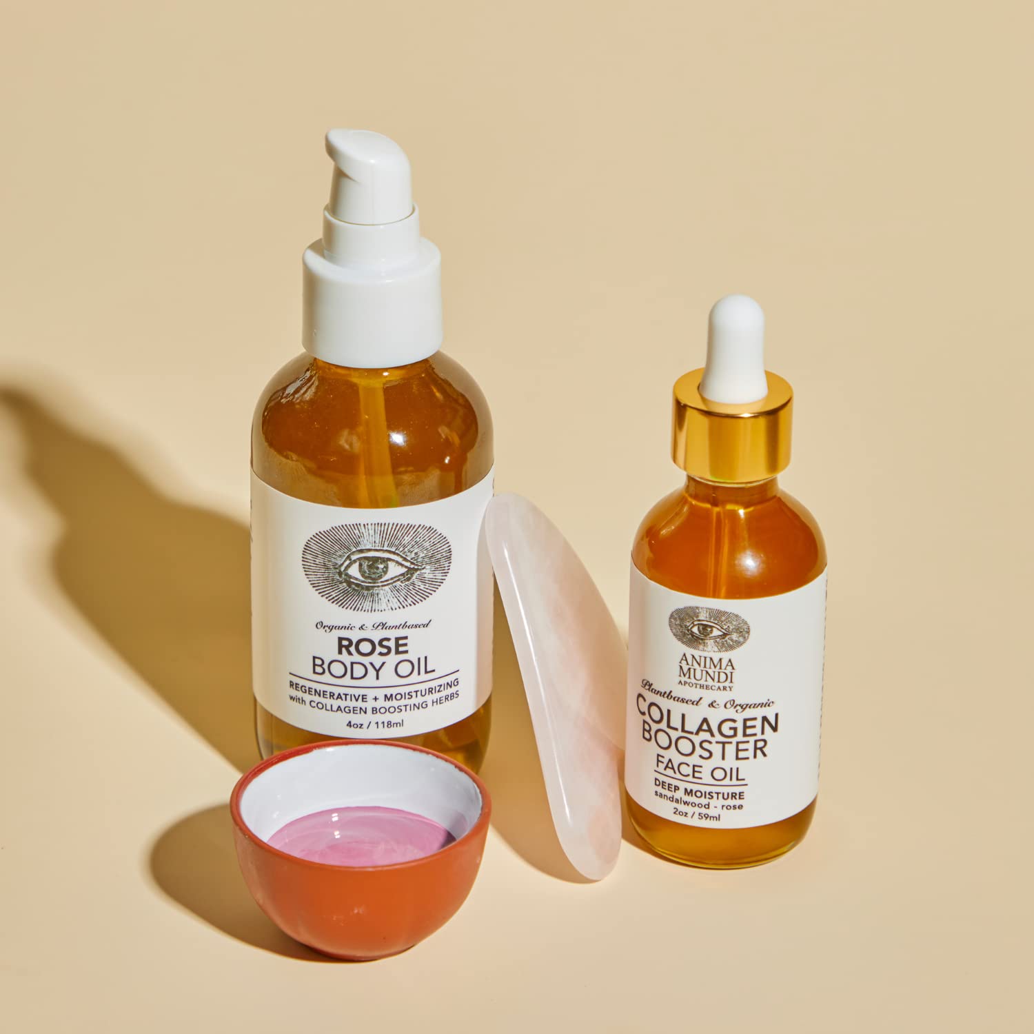 Anima Mundi product close-up showing rose petals and essential oil.
