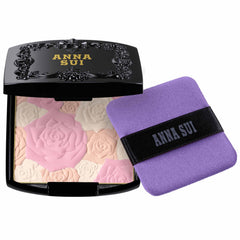 ANNA SUI Rose Pressed Powder compact with a rose-design interior for a silky, radiant finish.