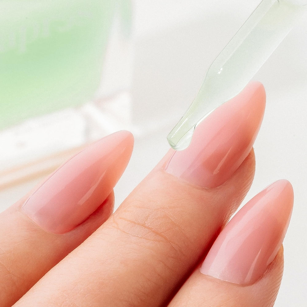 APRÉS Cuticle Serum massaged into nails for spa‑like care.