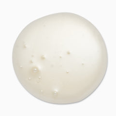 In-use shot shows rich cream texture dispensing from pump.