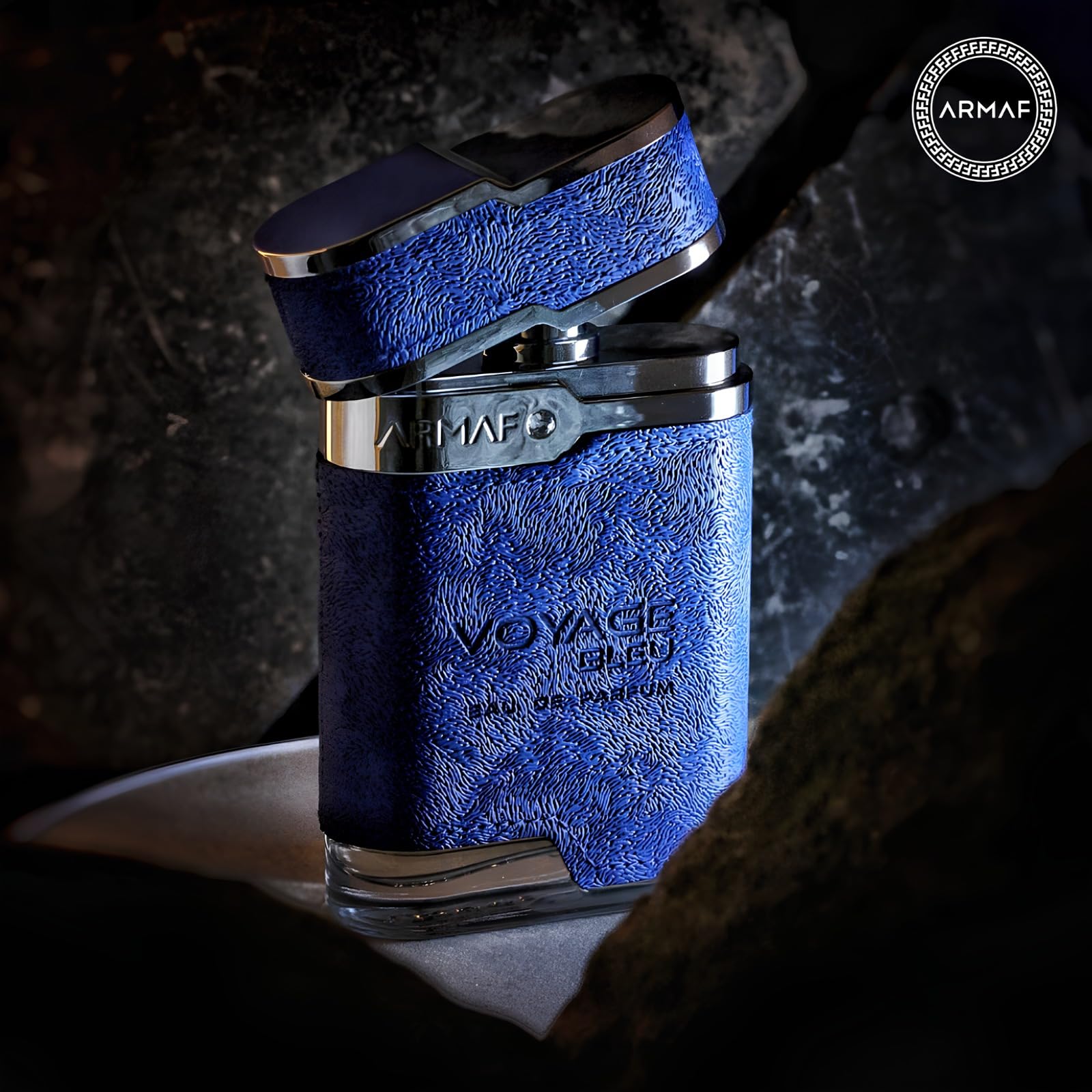 Armaf Voyage Blue flatlay, bottle with natural-toned styling.