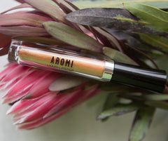 Aromi Gold Digger vegan cruelty-free logo signals ethical beauty choice.