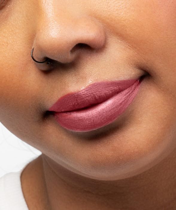 Aromi lipstick swatch on lips demonstrates long-lasting metallic finish and comfortable wear.