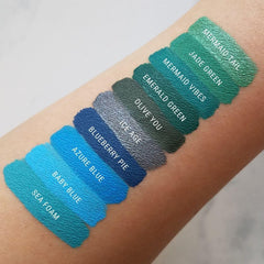 Aromi teal shimmer lip application captures a metallic finish