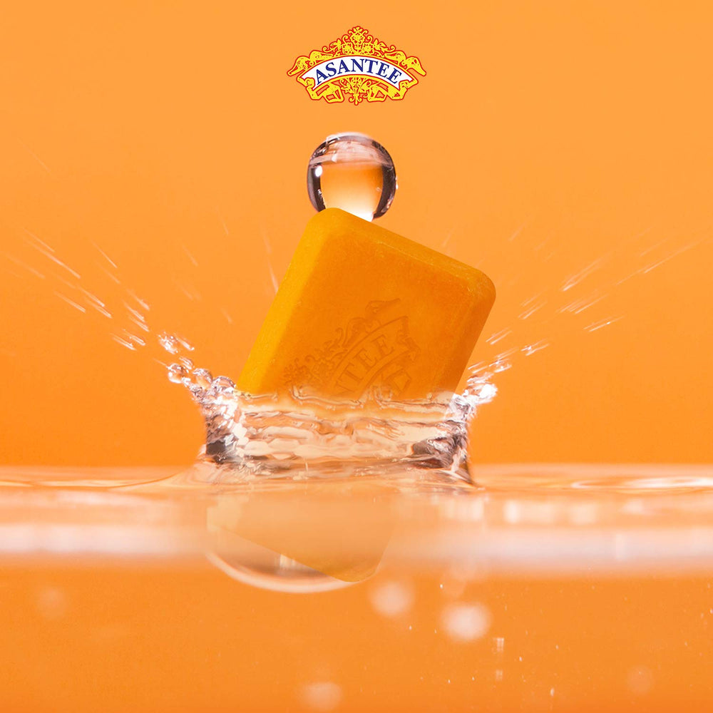 ASANTEE Papaya & Honey soap bar splash illustrating refreshing cleansing.
