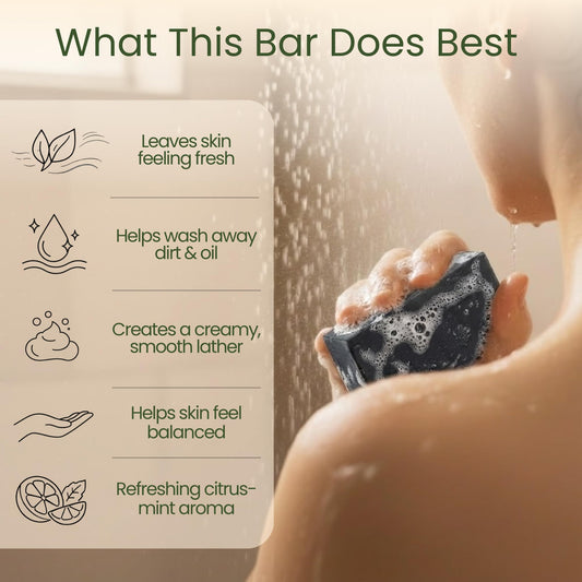 Close-up texture of Aspen Kay Naturals Dead Sea mud soap bar with charcoal specks.
