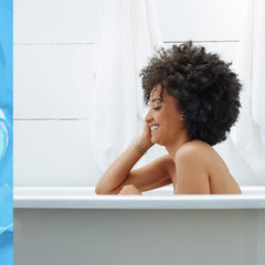 Salt crystals and oils help smooth dry patches on damp skin.