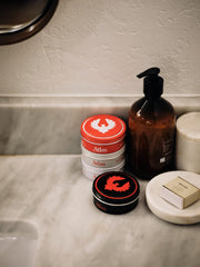 Atlas Pomade travel-sized tin demonstrates TSA-approved portability.