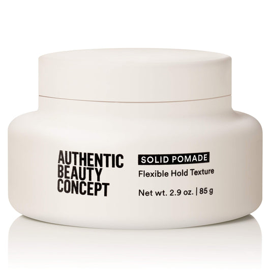 Authentic Beauty Concept Solid Pomade bottle closeup showing vegan formula for all hair types.