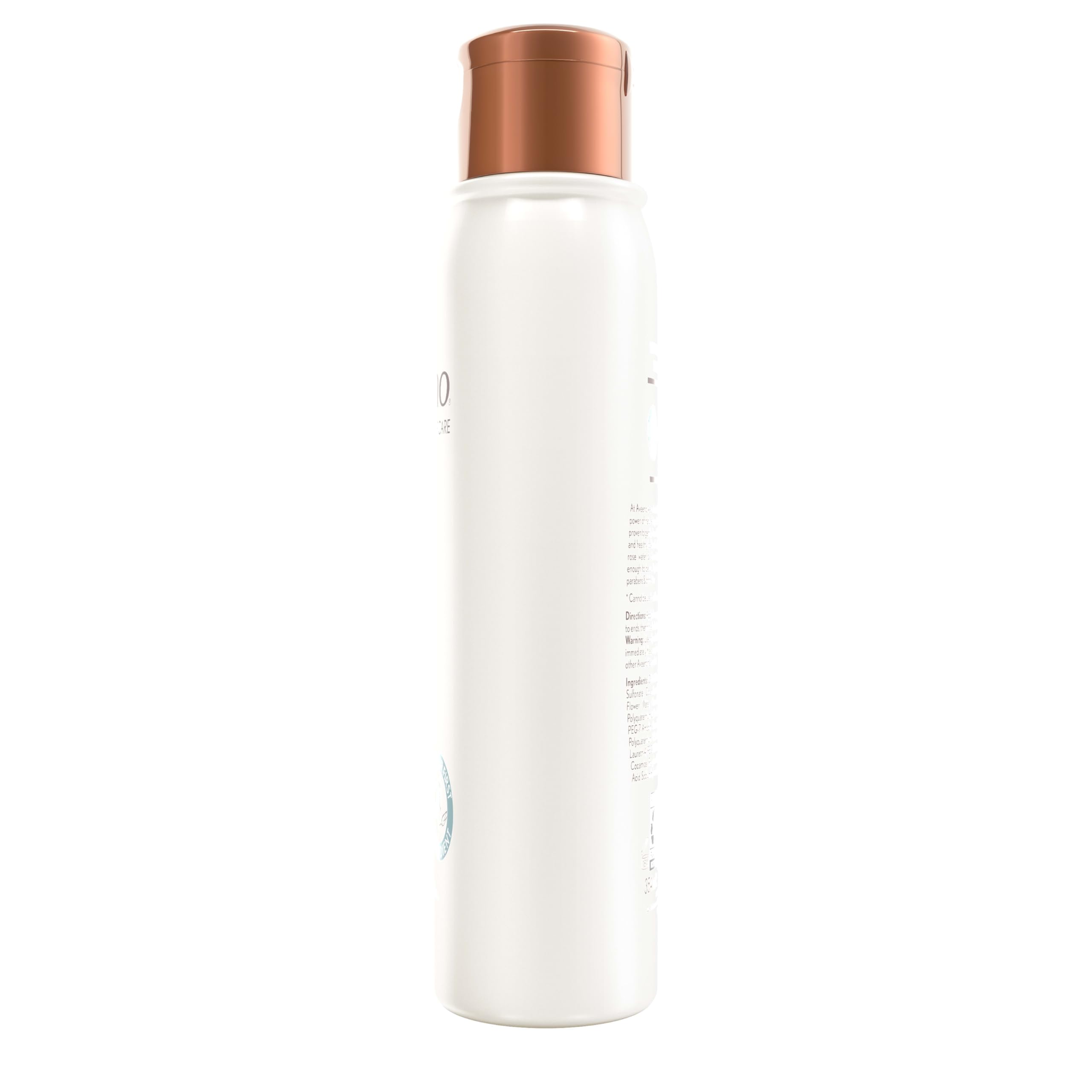 Aveeno bottle beside natural ingredients emphasized in clean formula.