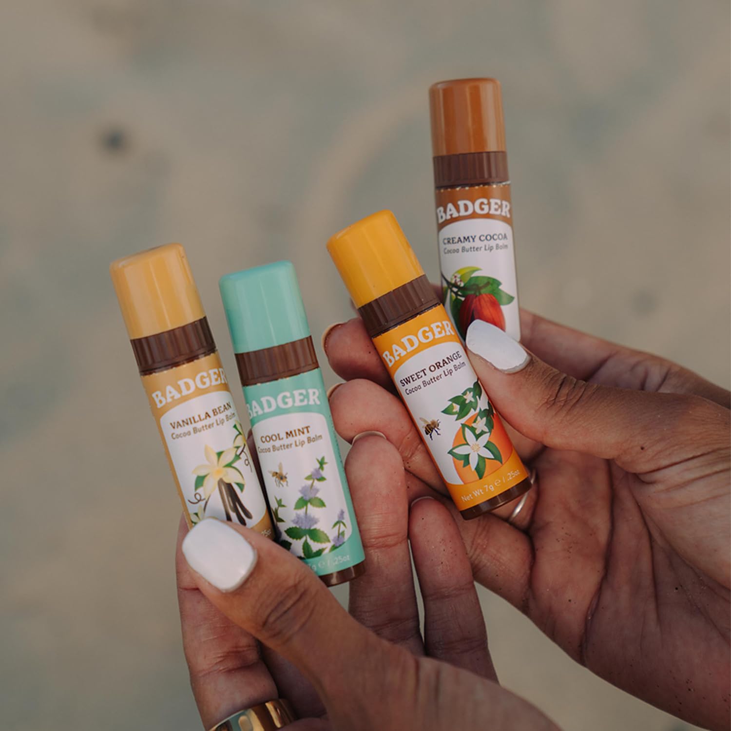 Applying Badger lip balm on lips for citrus aroma and moisture.