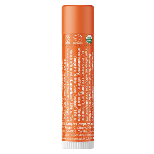 Close-up of Badger Tangerine Breeze lip balm tube top with smooth glossy application