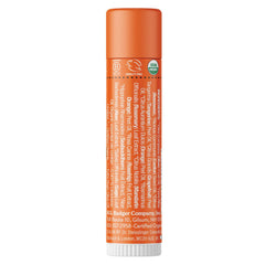 Close-up of Badger Tangerine Breeze lip balm tube top with smooth glossy application