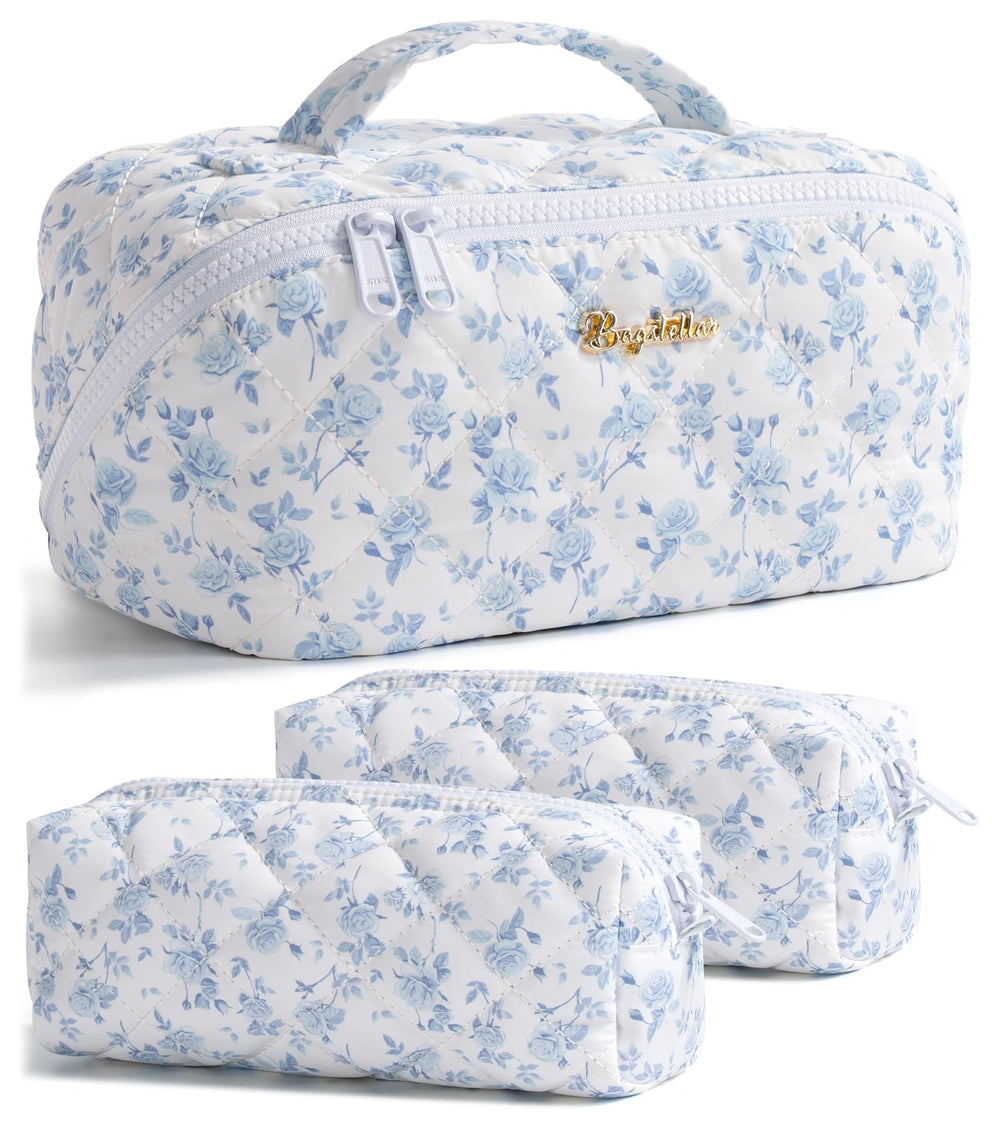Bagstellar travel makeup bag in blue floral design with open-flat layout for quick access.