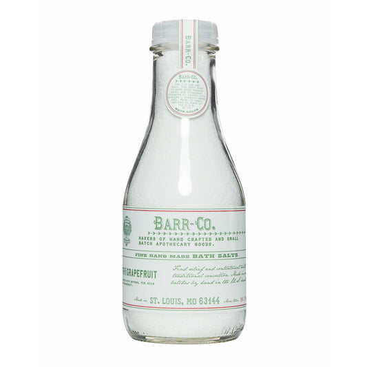 Barr-Co fir grapefruit bath salts jar shown in glass for relaxing soaks.