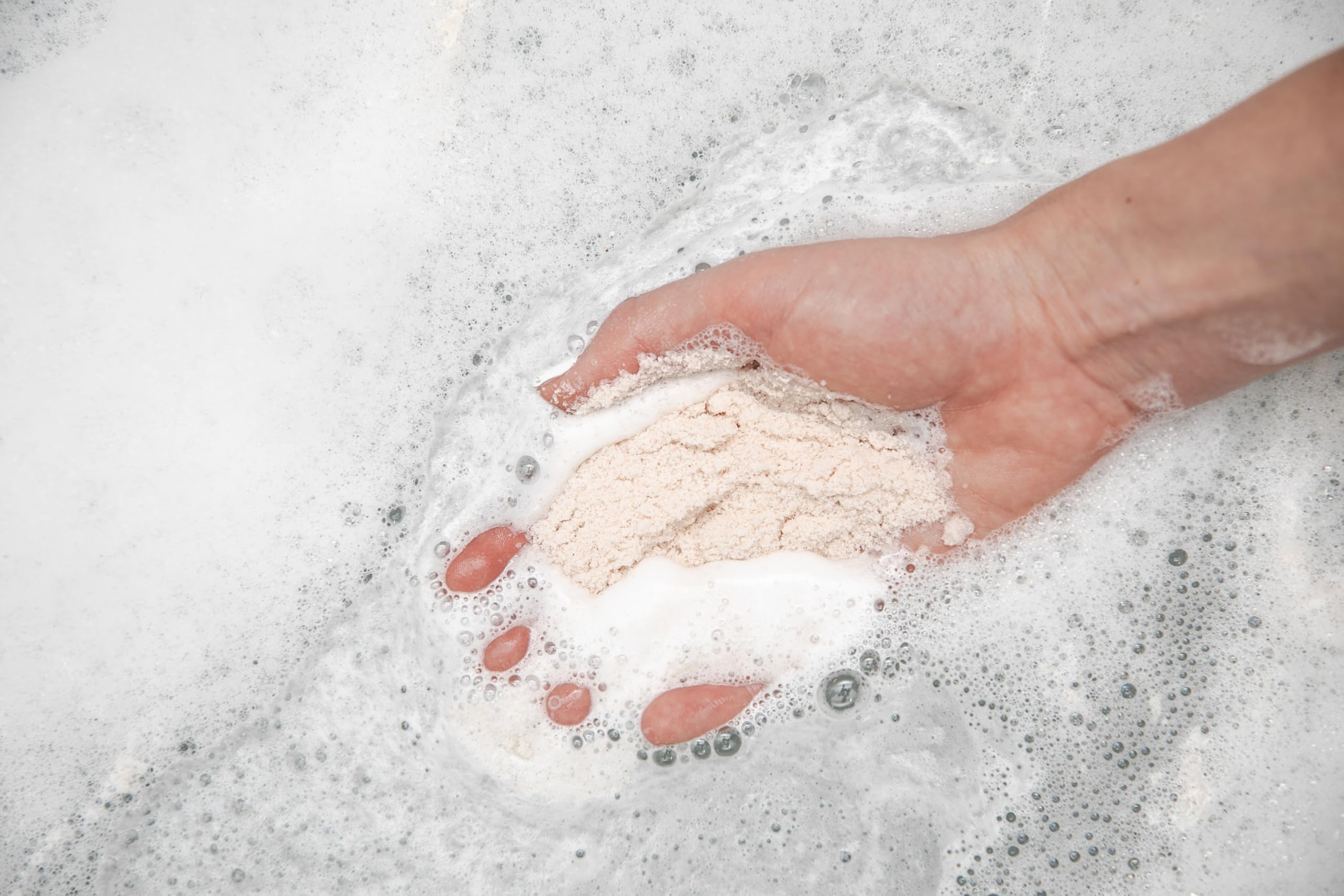 Kaolin clay and mineral blend forming a spa-like crema in the tub