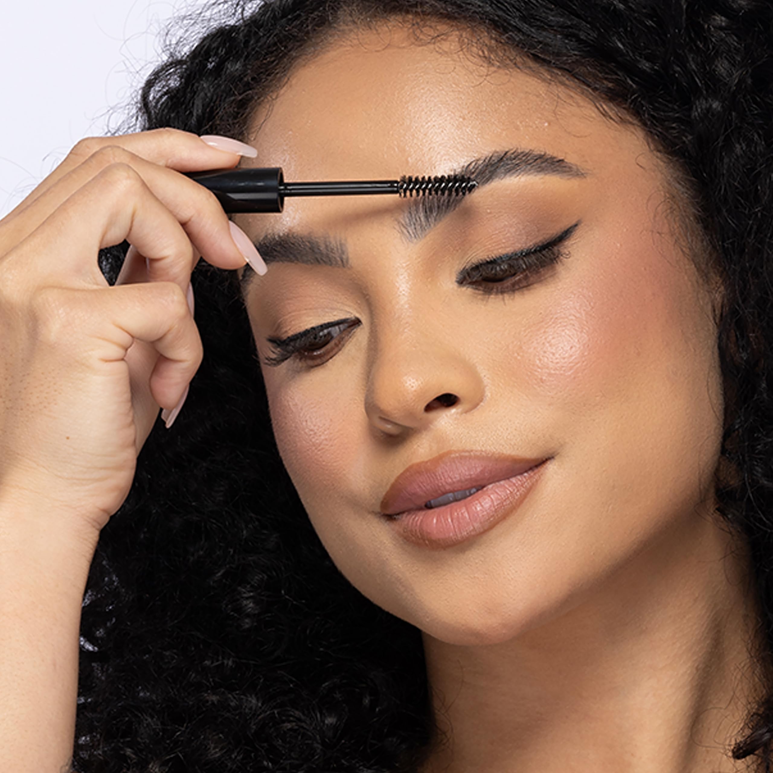 Billion Dollar Brows clear gel bottle demonstrates waterproof performance for activities.