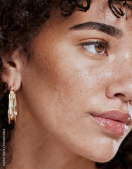 BE THE ENVY NV Perfecting Mist Bronzer spray on face demonstrates lightweight, skin-loving application