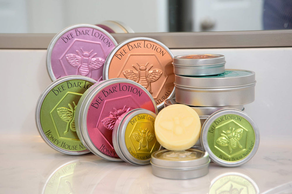 Bee Bar Honey House Naturals Duo Lavender on a workspace provides quick elbow and cuticle care.