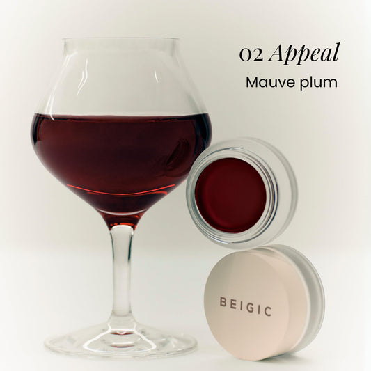 BEIGIC balm swatch on hand shows buildable mauve-plum shade