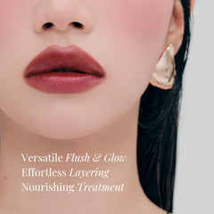 BEIGIC lip and cheek balm on lips for peach-coral glow.